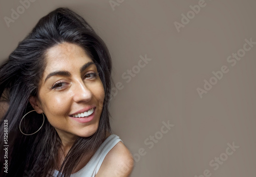 Beautiful young brunette smiling woman close-up portrait with copy space .Woman with white teeth 