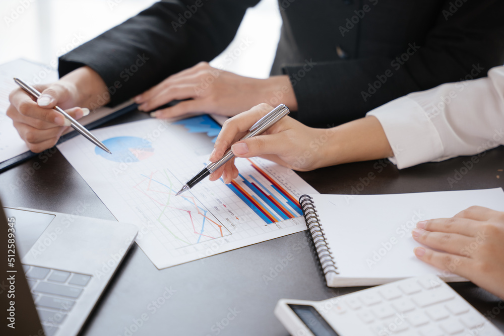 Close up of business women hands are discussed and calculating on paperwork that show accounting numbers tables on office space. Close up of business women hands are discussed and calculating on paperwork that show accounting numbers tables on office space.