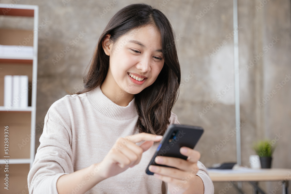 Young business woman discussing work via smartphone with happy face. Young business woman discussing work via smartphone with happy face.