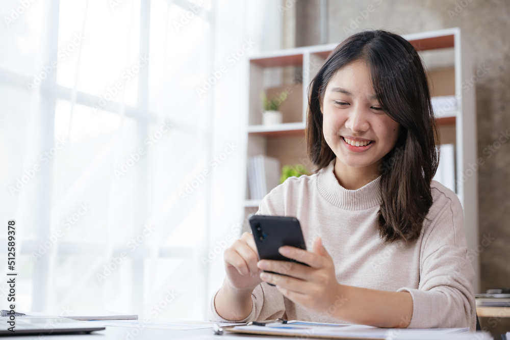 Young business woman discussing work via smartphone with happy face. Young business woman discussing work via smartphone with happy face.
