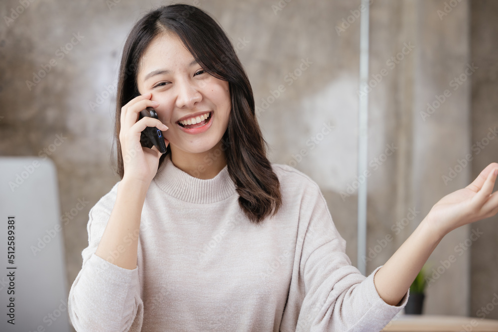 Young business woman discussing and talking work via smartphone with happy face. Young business woman discussing and talking work via smartphone with happy face.
