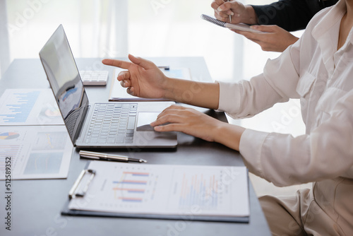 Close up of business women hands are discussed and calculating on paperwork that show accounting numbers tables and working on laptop on office space.