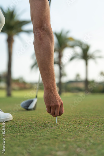 Man placing golf ball