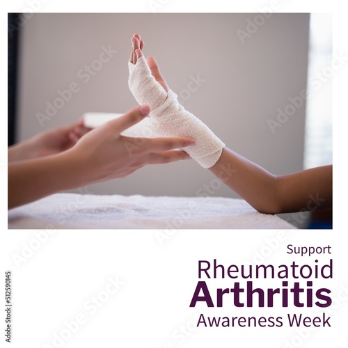 Caucasian doctor wrapping bandage on child's hand and support rheumatoid arthritis awareness week