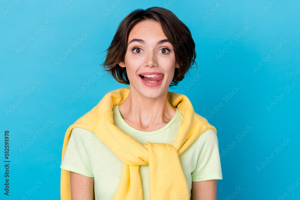Fototapeta premium Photo of nice millennial brunette lady lick teeth wear yellow t-shirt isolated on blue color background