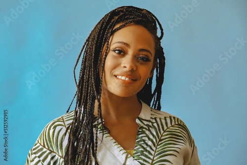 closeup portrait of smiling young beautiful african american woman braid hair posing at studio looking at camera shot