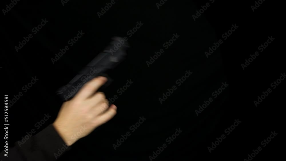 Cocking and firing a 9mm hand gun with black background