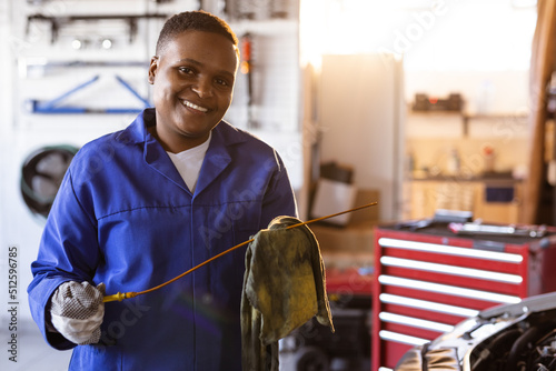 Portrait of smiling mid adult african american female mechanic working in workshop, copy space photo