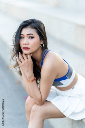 Portrait of beautiful athletic young asian woman in fashionable sportswear standing and having rest after strong exercise training in garden the park,Outdoor Sporty concept