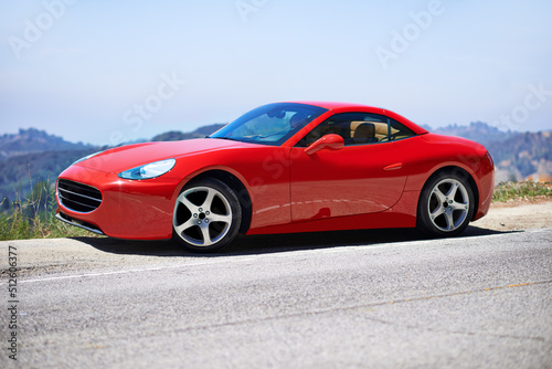 Red cars go faster. Shot of a young woman driving in a sports car.