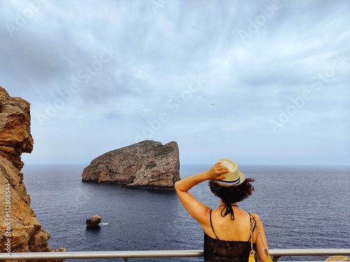tourist observes foradada island in sardinia photo