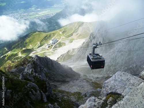 A cable car in the Austrian Alps above the Nordkette Singletrack Trail and Innsbruck in the valley below.