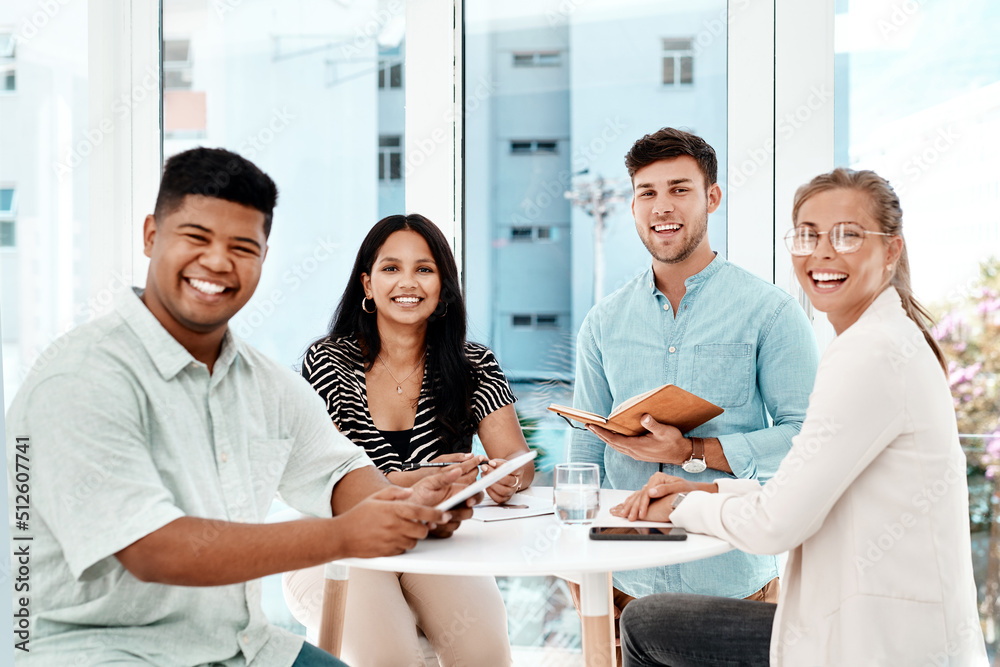 Fototapeta premium Were the team you need. Cropped portrait of a group of young business colleagues gathered around a table in their office.