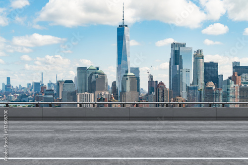 Empty urban asphalt road exterior with city buildings background. New modern highway concrete construction. Concept of way to success. Transportation logistic industry fast delivery. New York. USA. photo