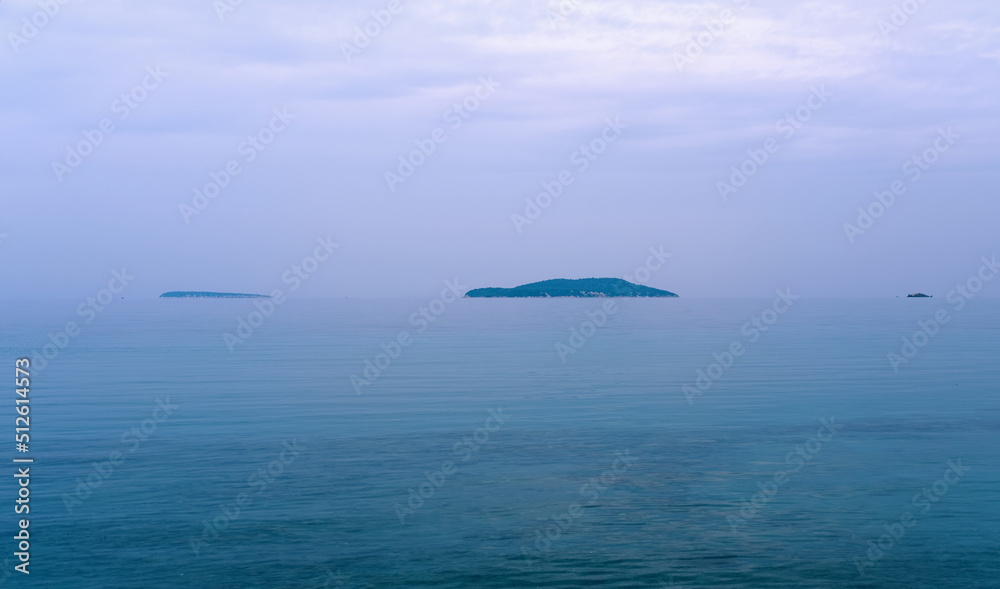 Minimal panoramic view of islands on the sea, sky and clouds on a moody overcast day