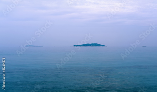 Minimal panoramic view of islands on the sea, sky and clouds on a moody overcast day