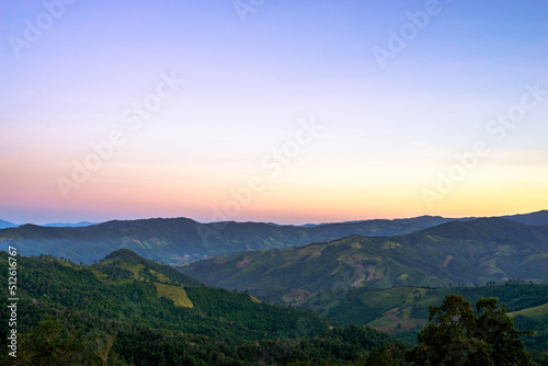 Beautiful sunrise scenic with light shade into the mountain © Phatara Thitiwimol