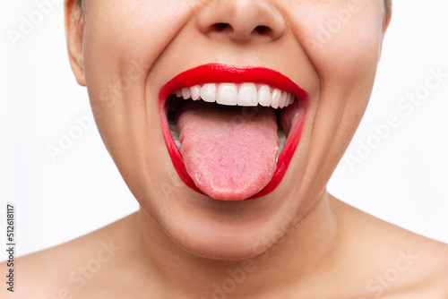 Fotografie, Obraz Cropped shot of young caucasian woman showing tongue with her mouth wide open isolated on a white background