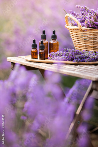 Amber essential lavender oil bottle. Violet lavendar field in Provence.