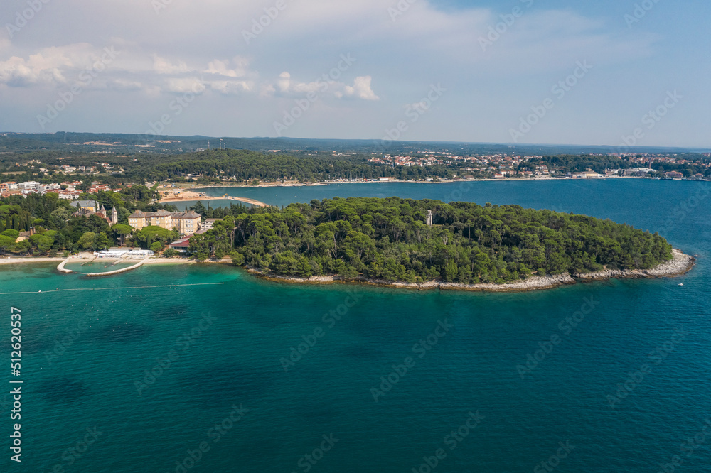 Aerial view of the a beach in Rovinj with a forest on the Adriatic sea in Croatia