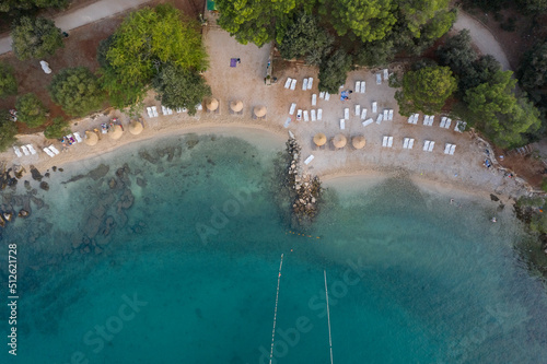 Fototapeta Naklejka Na Ścianę i Meble -  Aerial top view of a beach with turquoise blue green sea water of the adriatic sea, Rovinj, Croatia 