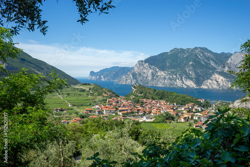 view of Lake Garda and the village of Nago, vineyards and mountains on a sunny summer morning © AndreaR