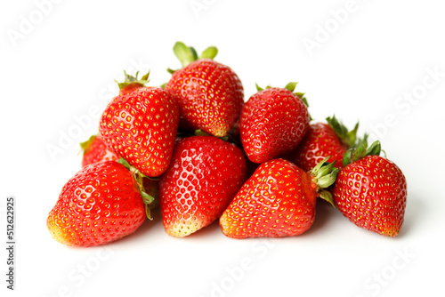 Ripe red strawberries with green leaves on a white background. Selective focus.