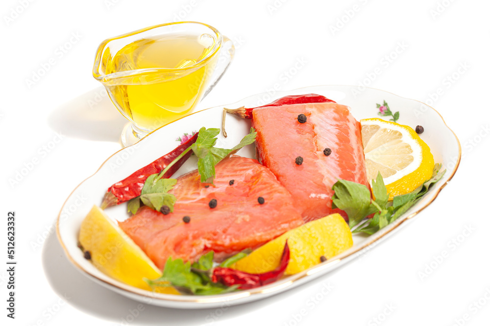 Pieces of lightly salted trout with spices, olive oil and lemon isolated on white background Pieces of lightly salted trout with spices, olive oil and lemon isolated on white background
