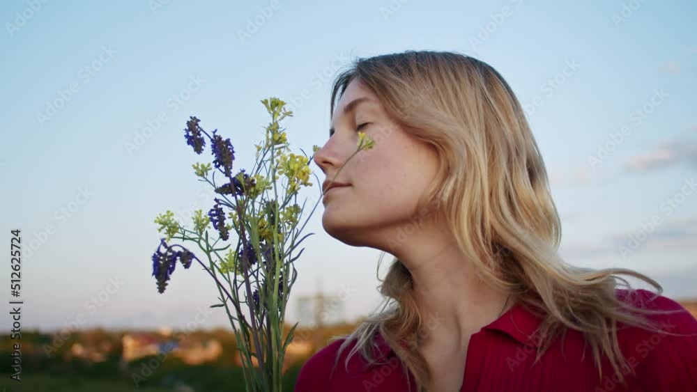 a young woman happily picks flowers on the mountain hills during sunset, for rest after a hike. rest of one person in nature, in the mountains. a young woman happily picks flowers on the mountain hills during sunset, for rest after a hike. rest of one person in nature, in the mountains.