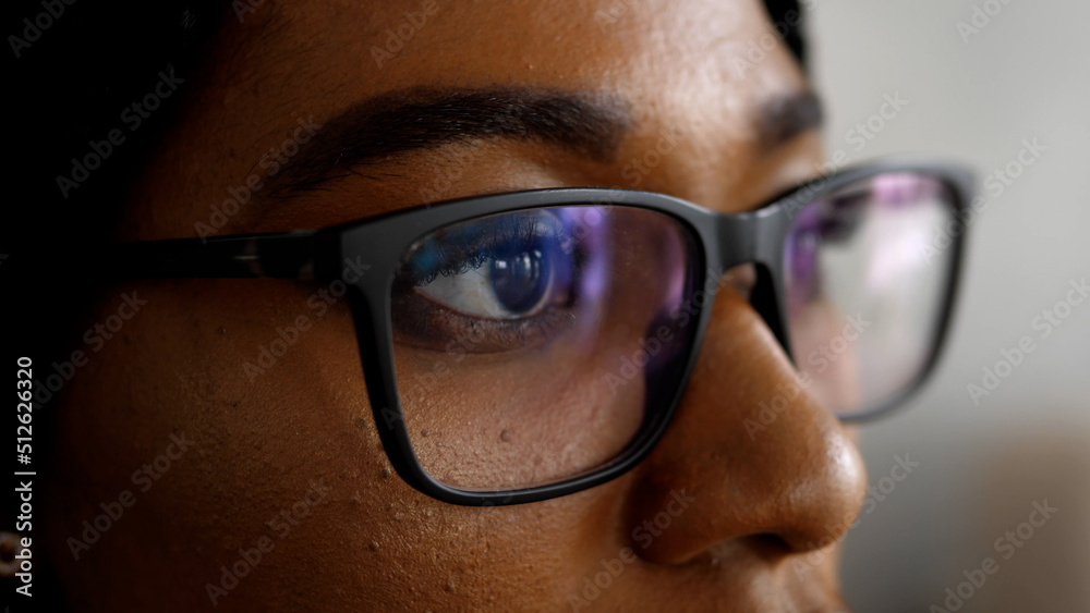 Close-up of a smart business woman wearing computer glasses looking at a computer screen, using the Internet, reading information, watching, working on the Internet. Close-up of a smart business woman wearing computer glasses looking at a computer screen, using the Internet, reading information, watching, working on the Internet.