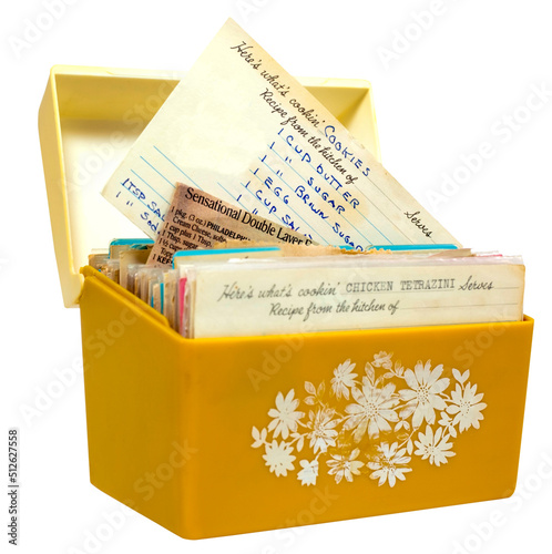 Old, yellow 1960s recipe box with handwritten recipes on index cards.