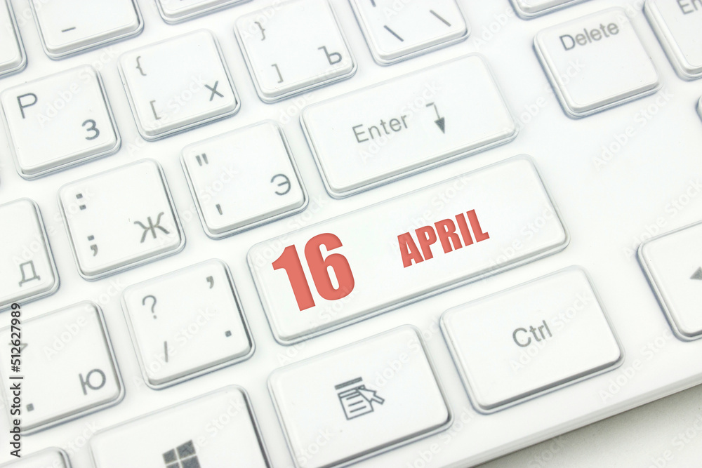April 16th. Day 16 of month, Calendar date. Cropped view of Modern White Computer Keyboard with calendar date. Concept workspace, freelance, deadline. Spring month, day of the year concept. April 16th. Day 16 of month, Calendar date. Cropped view of Modern White Computer Keyboard with calendar date. Concept workspace, freelance, deadline. Spring month, day of the year concept.