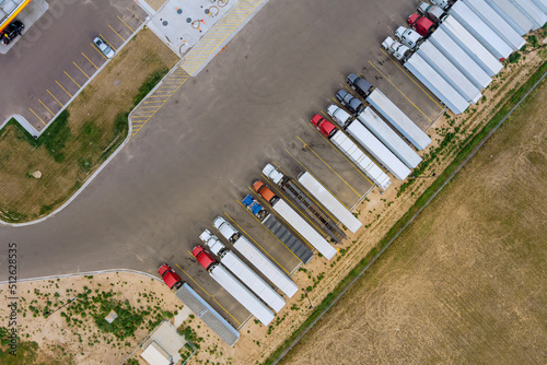 Aerial top view truck stop parking at the rest area on the highway trucks stand in a row