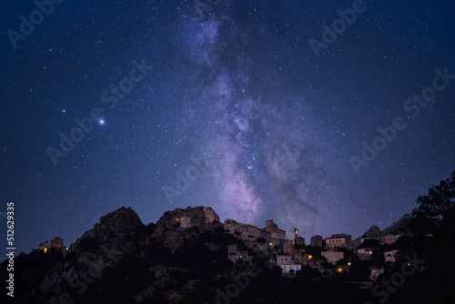 Composite image of the milky way over the ancient mountain village of Speloncato in the Balagne region of Corsica photo
