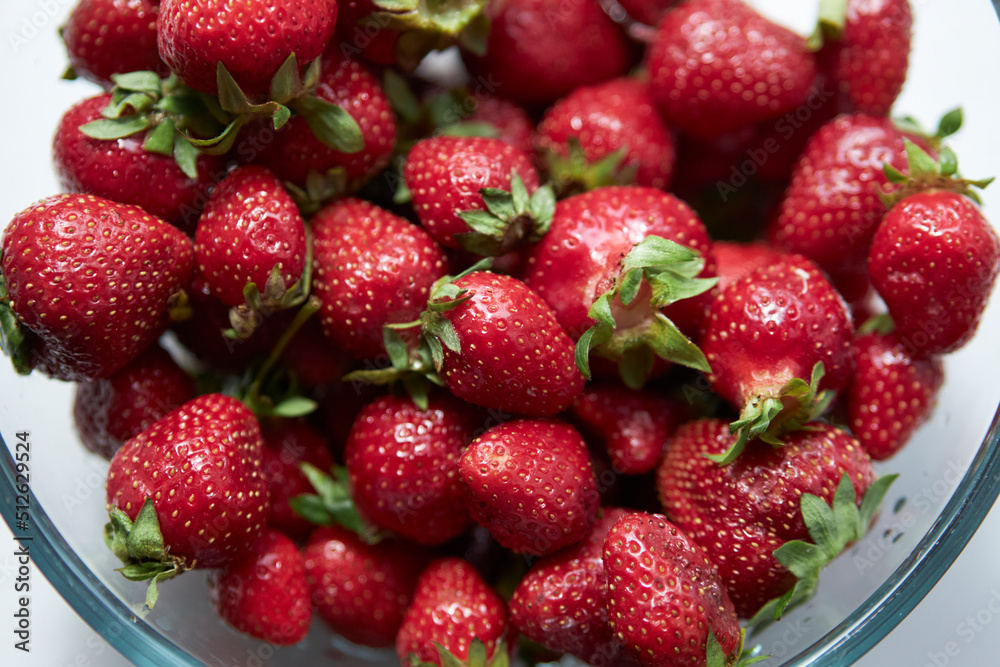 Strawberries in a glass plate close-up. Seasonal berry. 