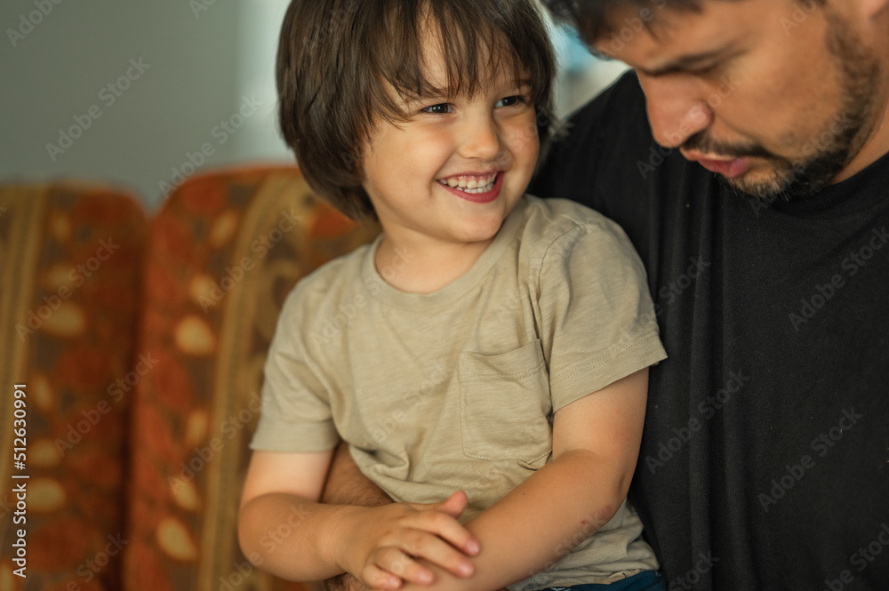 the faces of the father and son are close-up, the father spends time with his son, he talks to him, they laugh and smile, the concept of a happy family the faces of the father and son are close-up, the father spends time with his son, he talks to him, they laugh and smile, the concept of a happy family