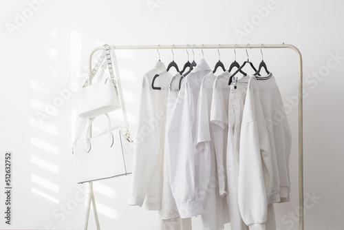 female white capsule summer wardrobe in white room