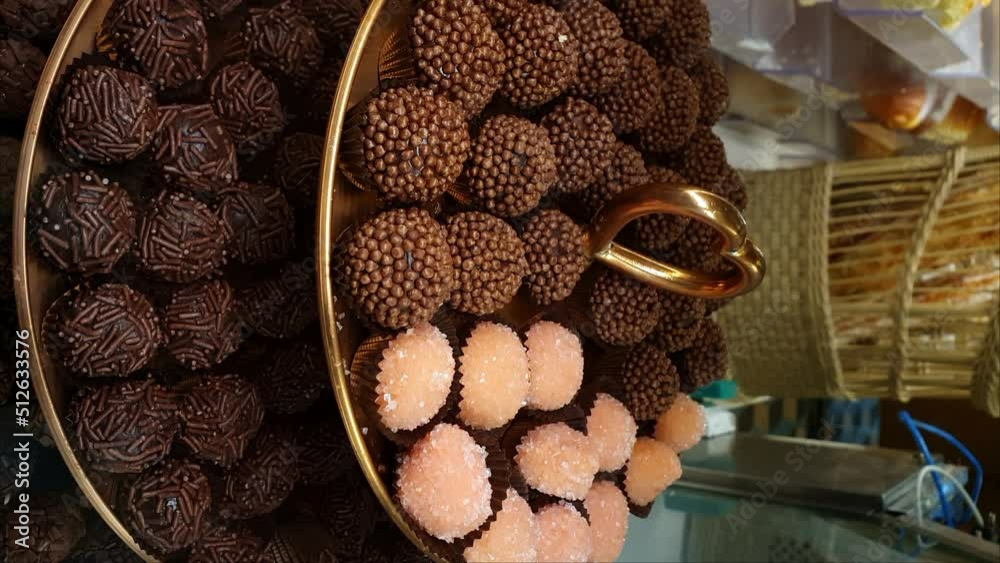 Tower closeup with several brigadiers. Traditional Brigadeiro and bicho de pe_vertical.