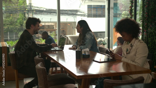 Customers inside coffee shop in conversation. Interior of cafe