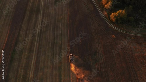 Harvester on the field at sunset