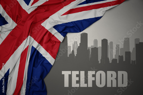 Canvas Print abstract silhouette of the city with text Telford near waving national flag of great britain on a gray background