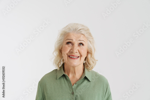 Grey senior woman in shirt smiling and looking upward
