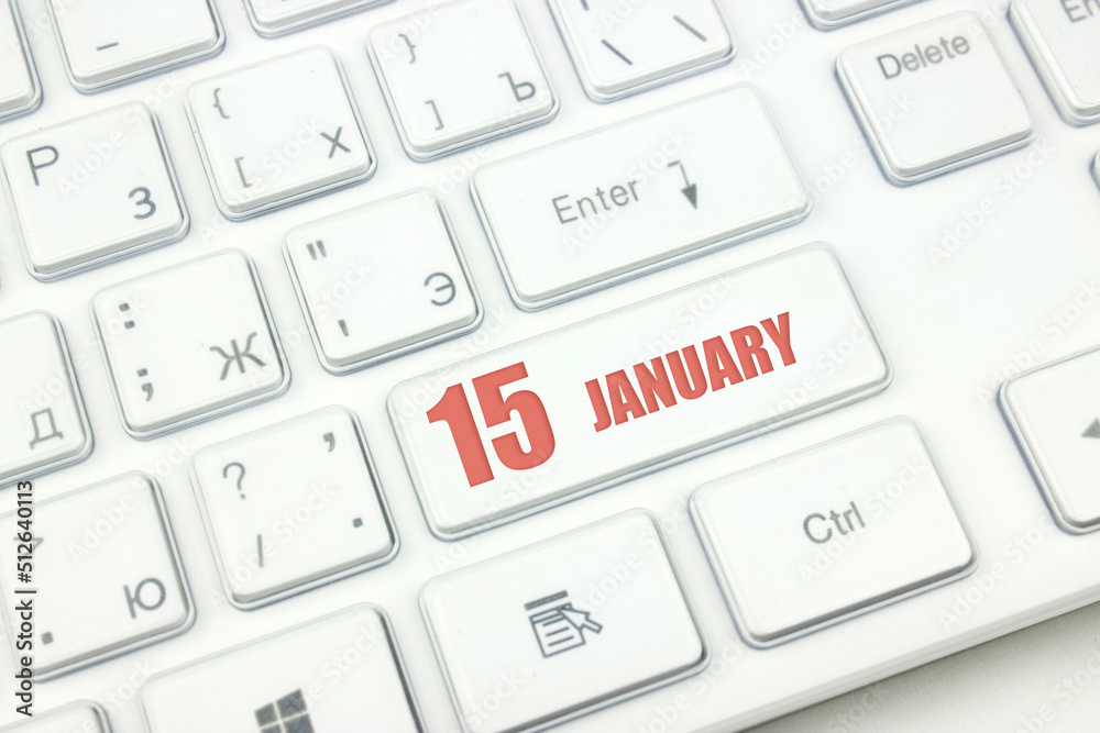 January 15th. Day 15 of month, Calendar date. Cropped view of Modern White Computer Keyboard with calendar date. Concept workspace, freelance, deadline.  Winter month, day of the year concept.