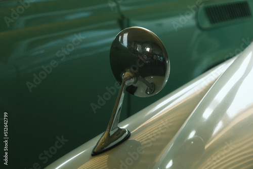 Side mirror near the car. Bright glossy side mirror of a classic retro car.