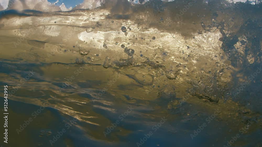 Ocean wave breaks on the shore at sunrise Ocean wave breaks on the shore at sunrise