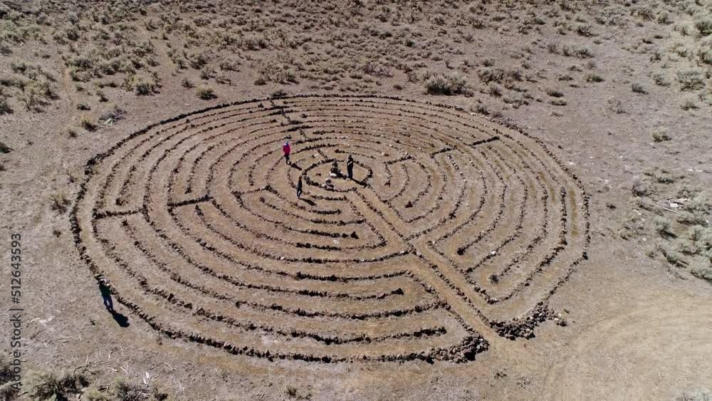 Aerial view of people moving on the path in a labyrinth from aerial view in the desert in Idaho. Aerial view of people moving on the path in a labyrinth from aerial view in the desert in Idaho.