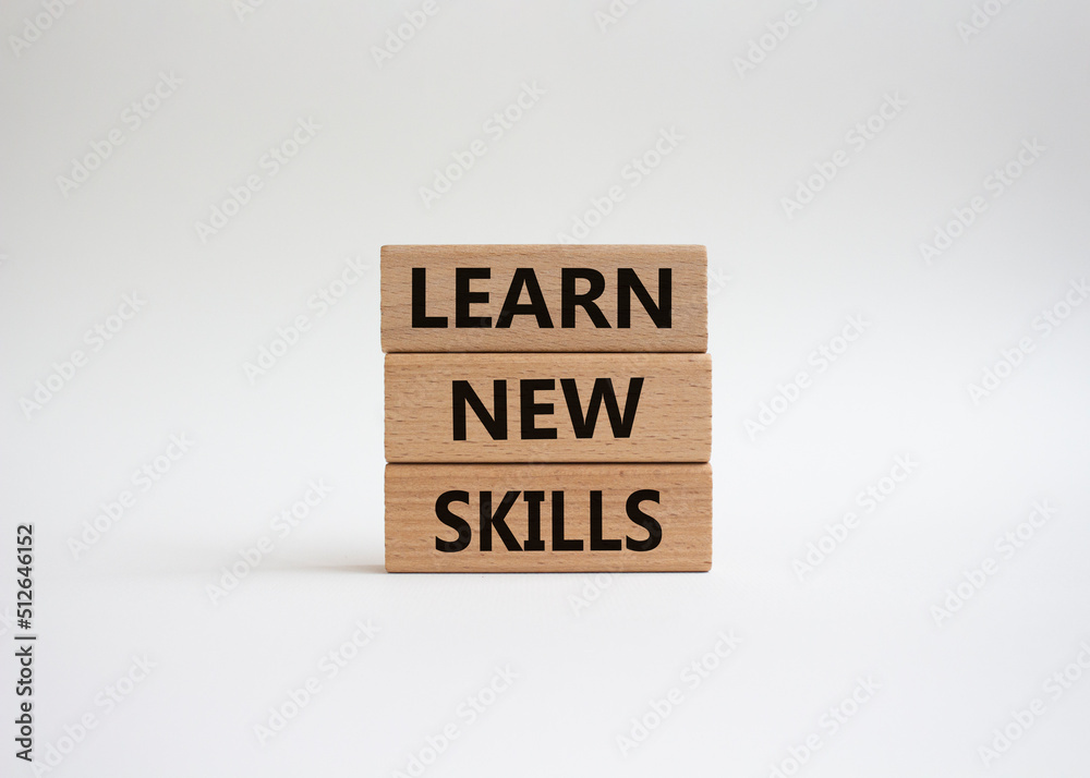 Learn new skills symbol. Concept words 'Learn new skills' on wooden blocks. Beautiful white background. Business and Learn new skills concept. Copy space. Learn new skills symbol. Concept words 'Learn new skills' on wooden blocks. Beautiful white background. Business and Learn new skills concept. Copy space.