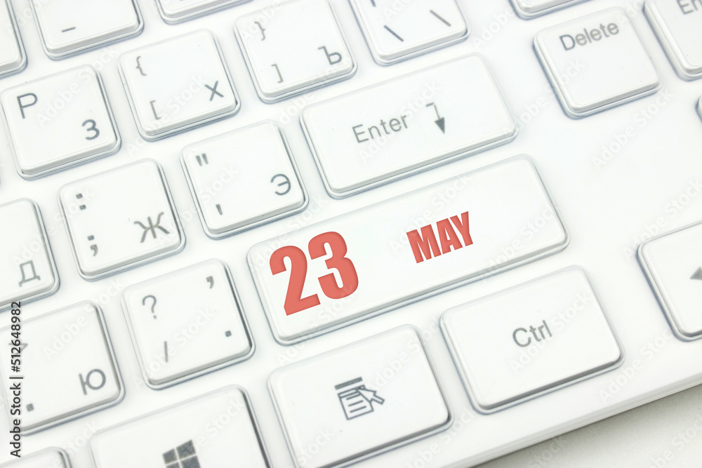 May 23rd. Day 23 of month, Calendar date. Cropped view of Modern White Computer Keyboard with calendar date. Concept workspace, freelance, deadline. Spring month, day of the year concept. May 23rd. Day 23 of month, Calendar date. Cropped view of Modern White Computer Keyboard with calendar date. Concept workspace, freelance, deadline. Spring month, day of the year concept.