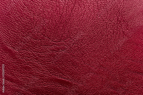 The texture of natural leather is red or burgundy. Leather background