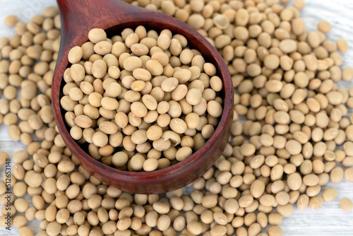 Close up of soybeans on a wood scope white table background